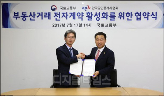 권대철 국토교통부 토지정책관(왼쪽)이 한국공인중개사협회와 지난 17일 세종 국토교통부 청사에서 부동산 전자계약 업무협약을 맺은 뒤 기념 사진을 찍고 있다.<국토교통부 제공>